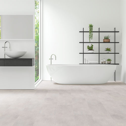 modern bathroom in black and white with neutral stone look tile floors and white bathtub