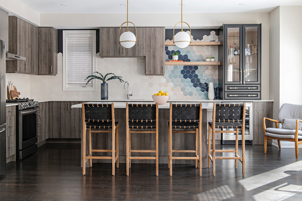 wood flooring in kitchen with colorful backsplash Design by Aman Than Interiors and Photography by Mike Chajecki 